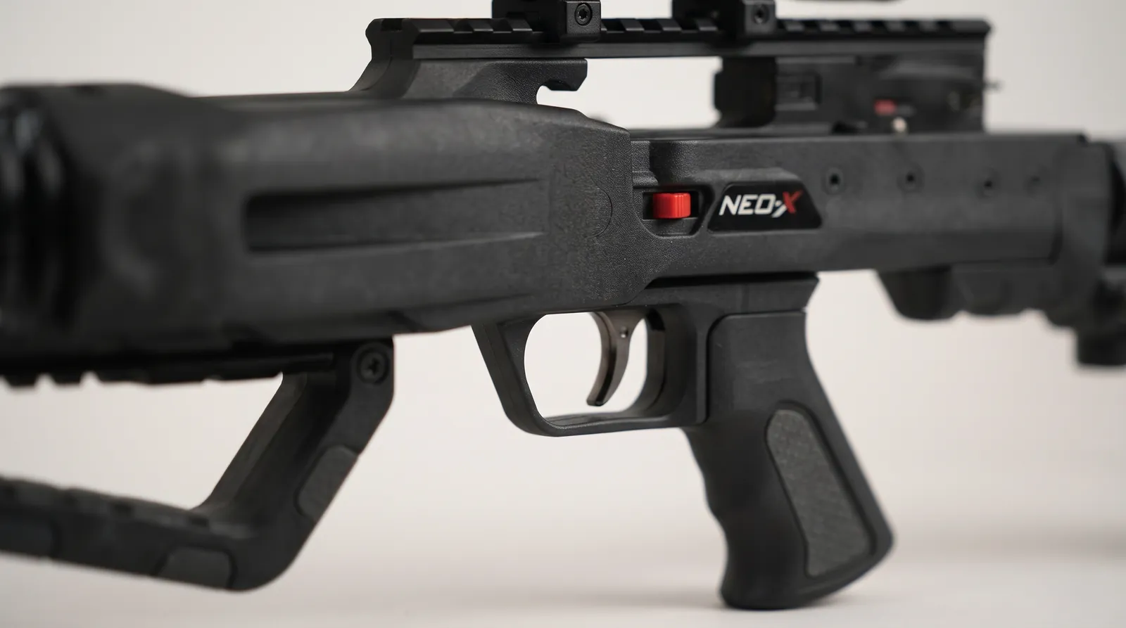 Close-up of a crossbow trigger housing and safety switch similar to the NEO-X DC Triggerbox