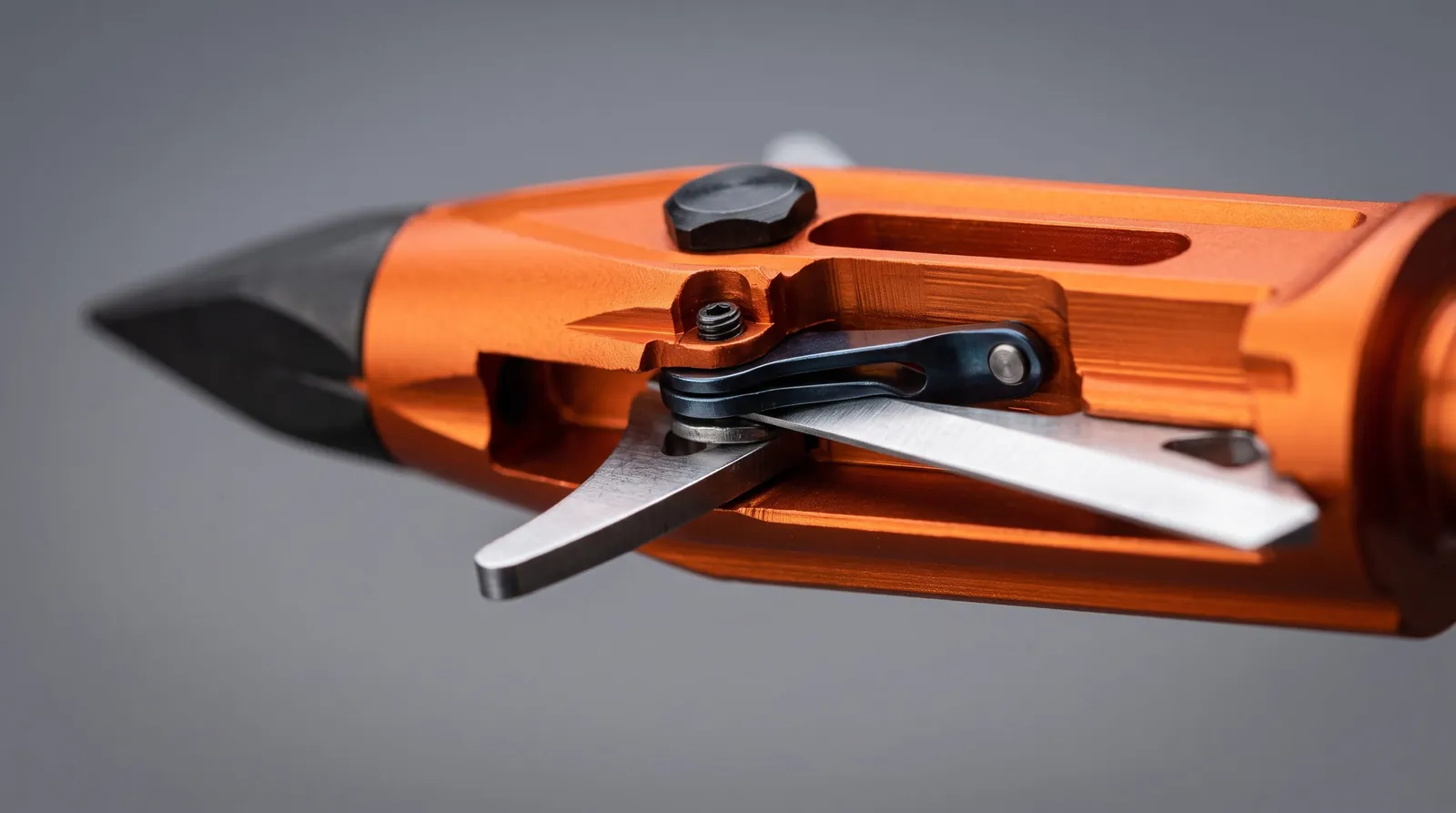 Close view of the R102 spring clip holding the rear blades folded against the body