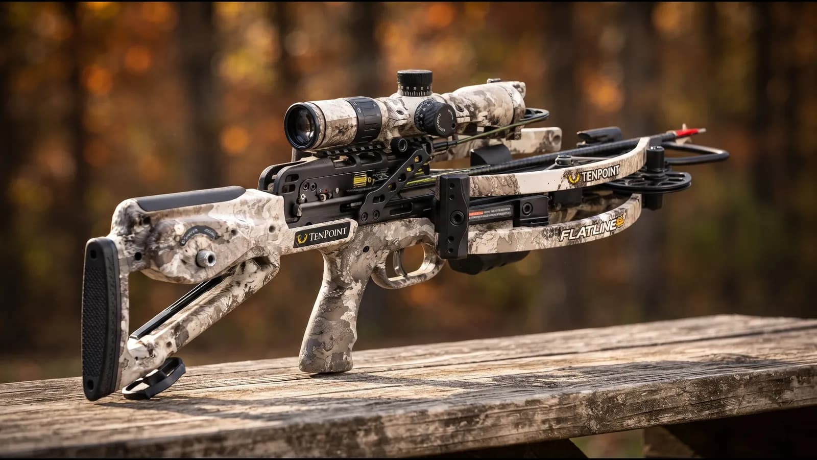 TenPoint Flatline 460 in light mountain camo with a black skeletonized rail and scope on a sunlit shooting bench