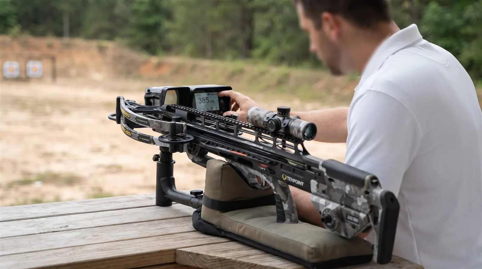 TenPoint TX Ultra 29.5 crossbow shooting a bolt through a chronograph on an outdoor range