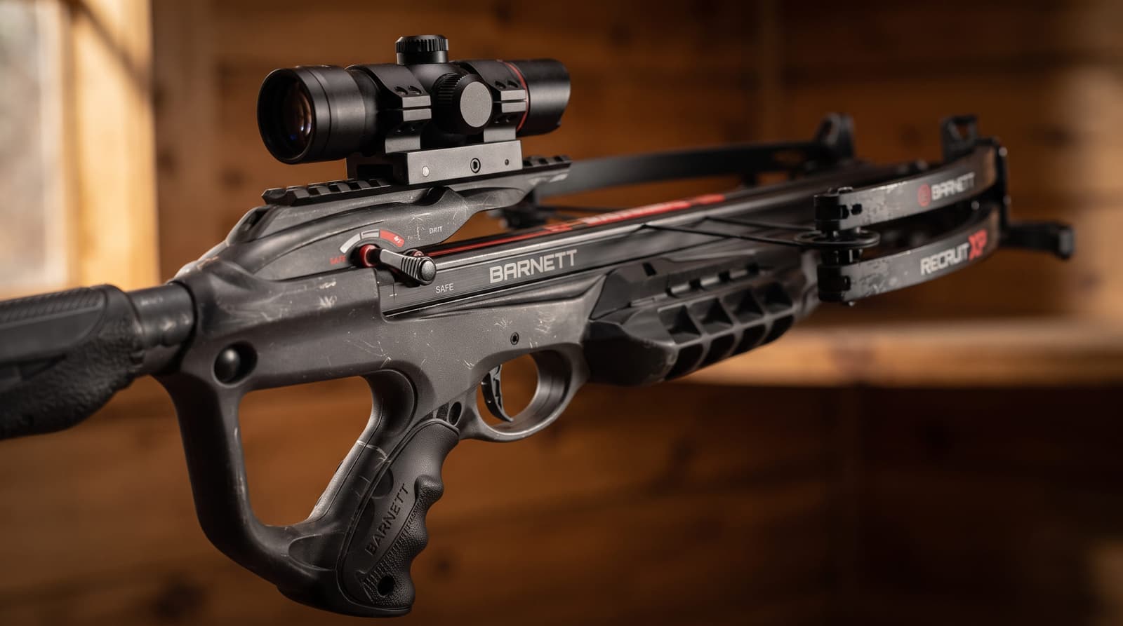 Close-up of a crossbow trigger area with pass-through foregrip and finger reminders