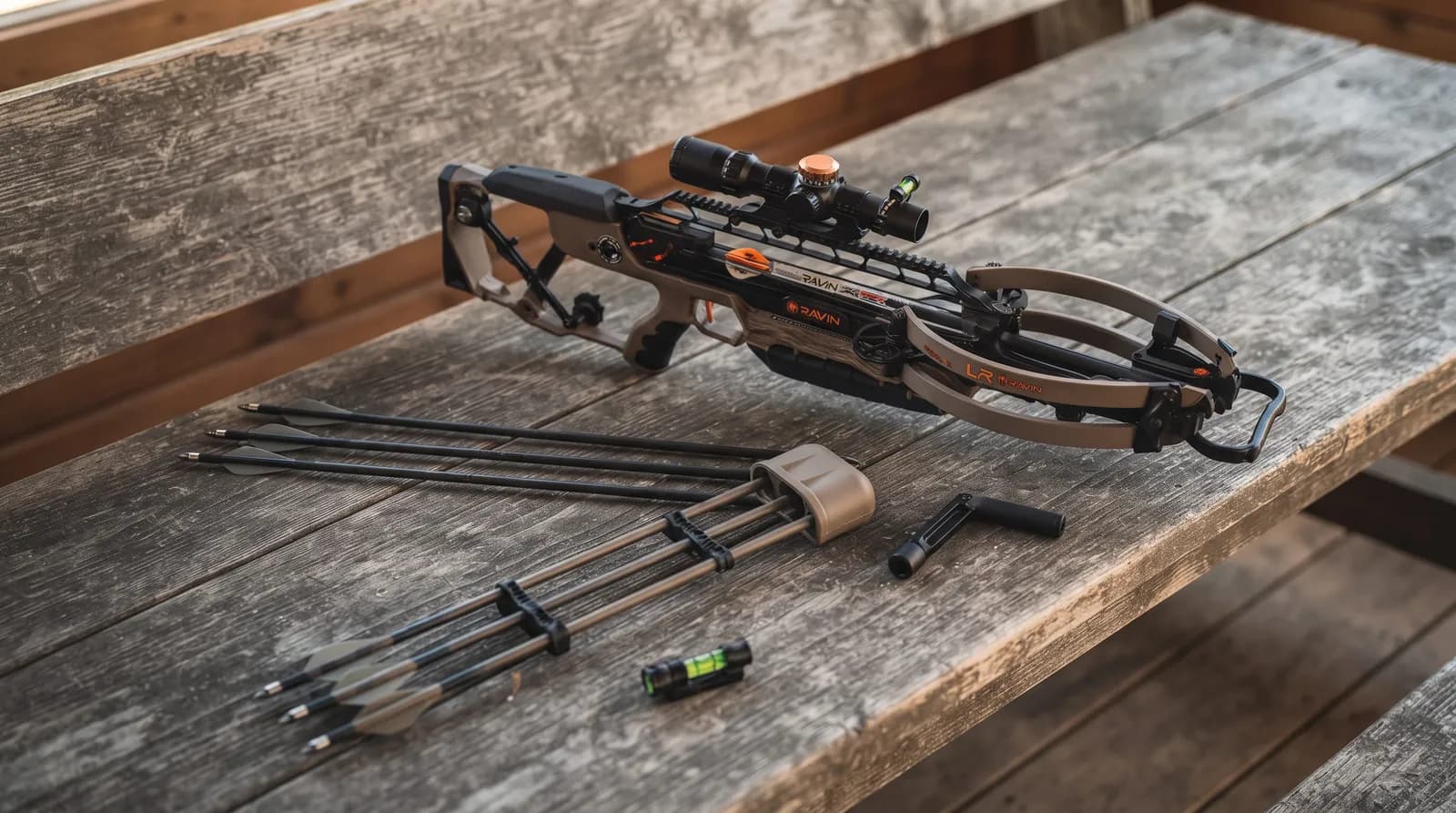 Ravin LR flat dark earth crossbow with turret scope, quiver and three arrows on a wooden bench