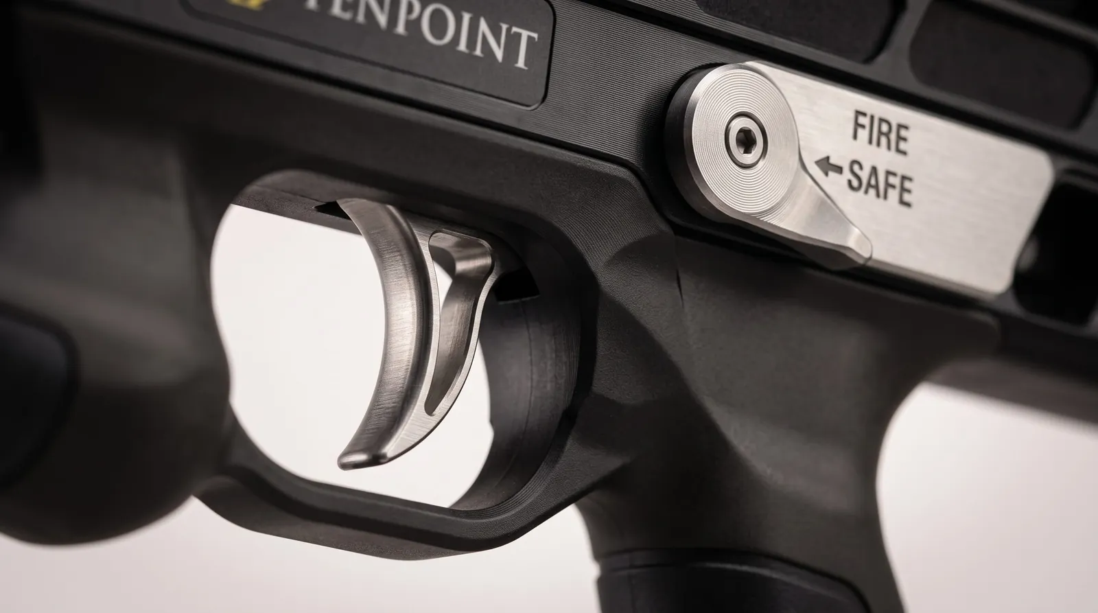Close view of a crossbow trigger and AR-style ambidextrous thumb safety lever
