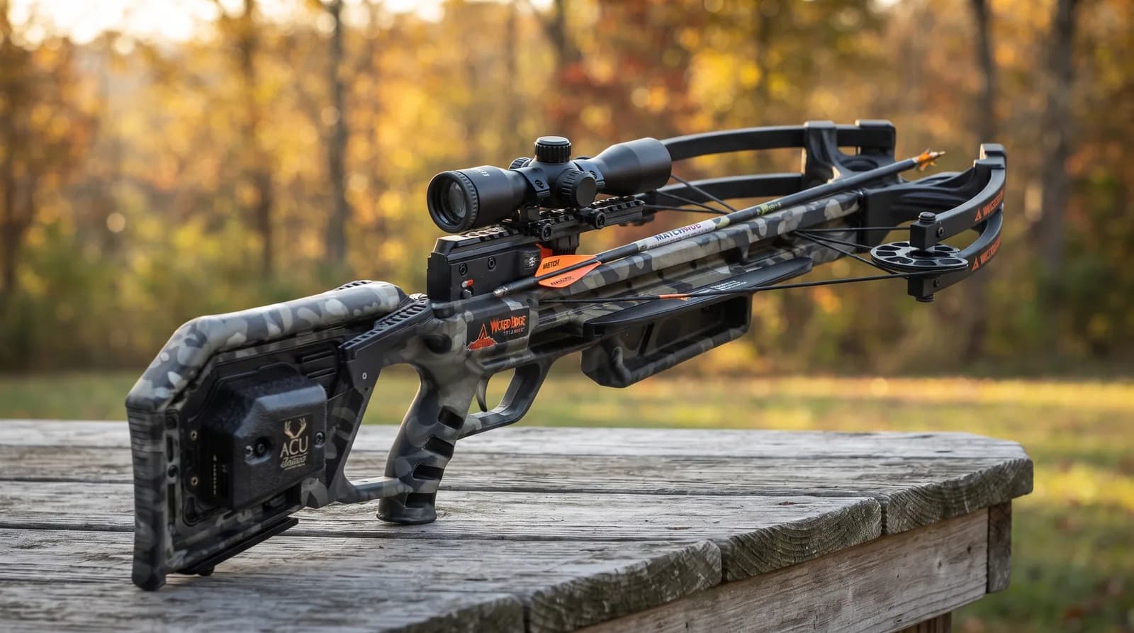 Wicked Ridge Commander 400 crossbow in camo with black limbs and a lighted scope on an outdoor bench